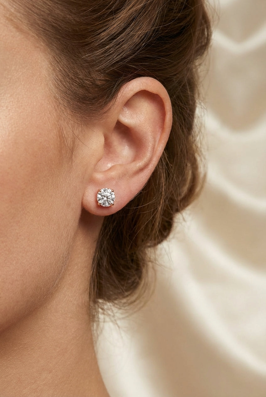 Round diamond stud earrings, 1 carat.